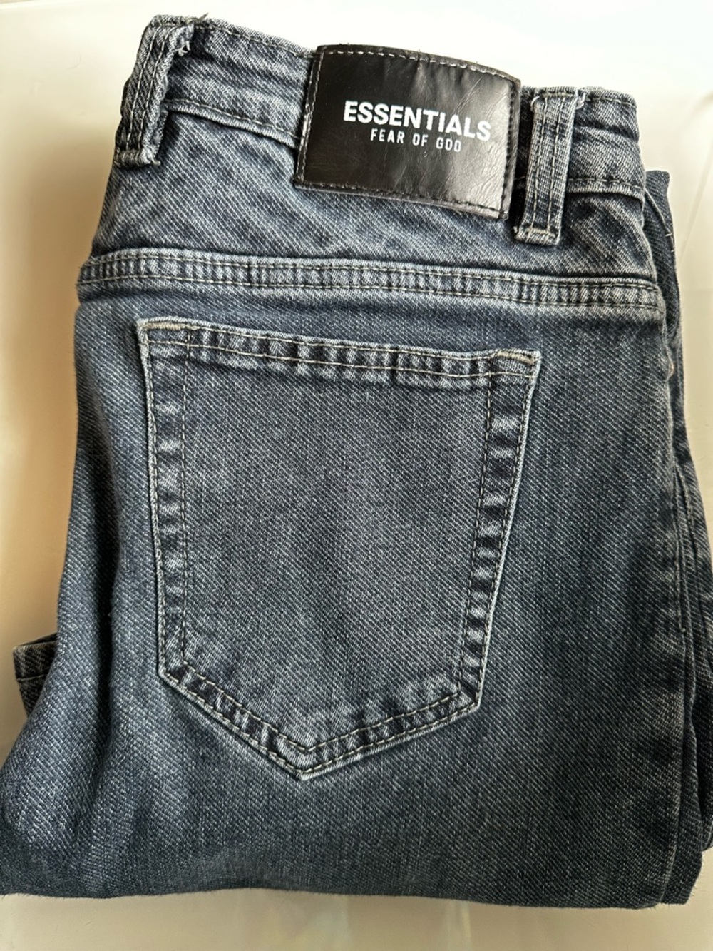 Fear of God Essentials Men's Slim Straight Jeans in Washed Blue. 100% cotton